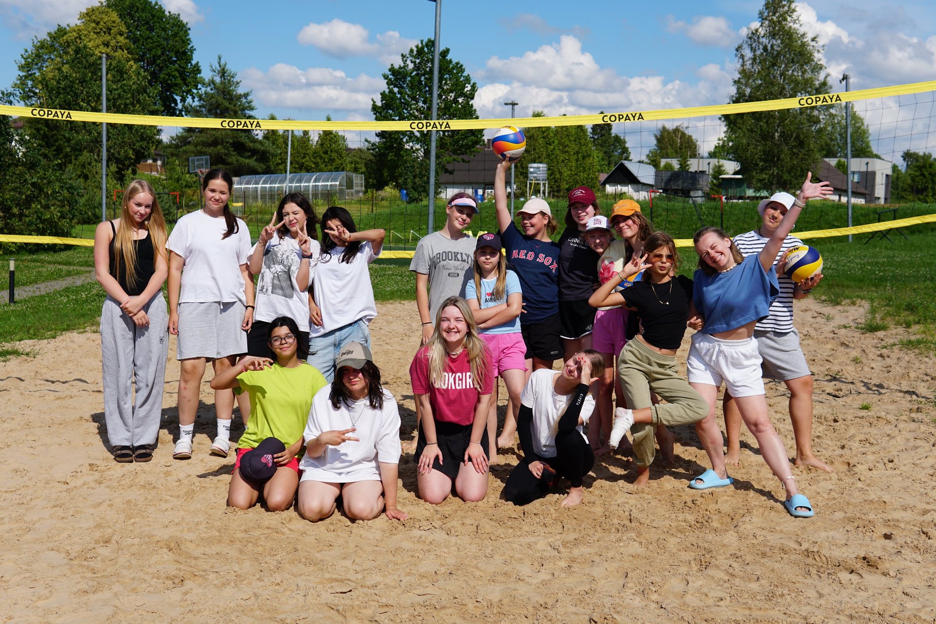 group of women standing on green grass field during daytime