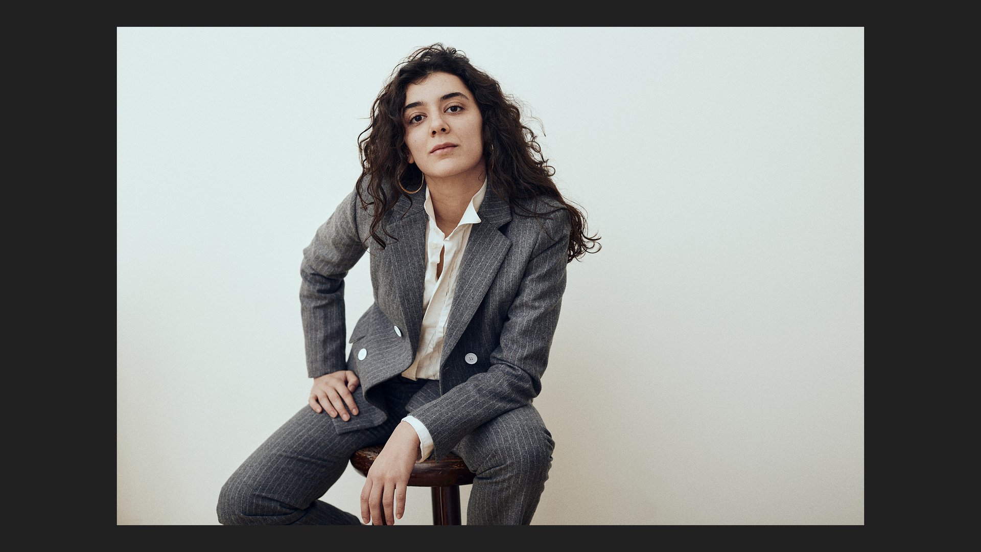 Nora Haddada sitting on a chair.