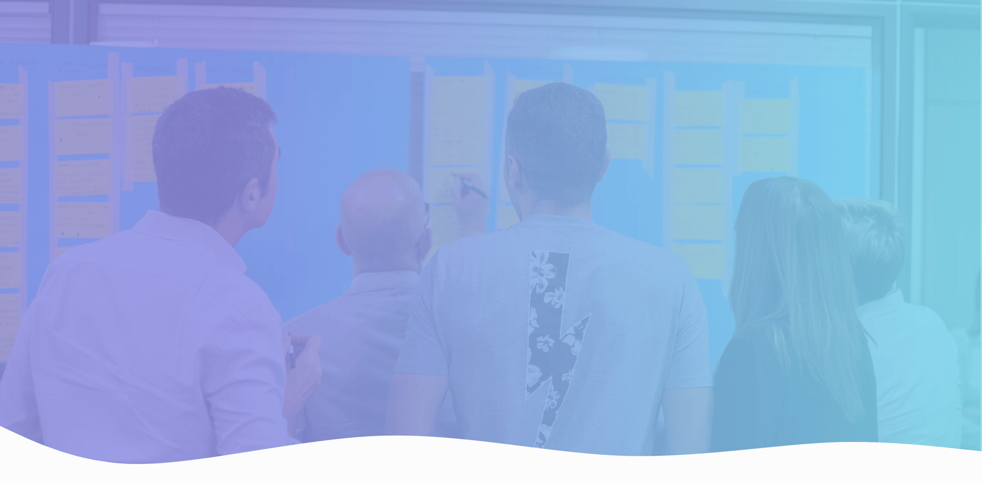 Workshop with participants discussing on a whiteboard with sticky notes