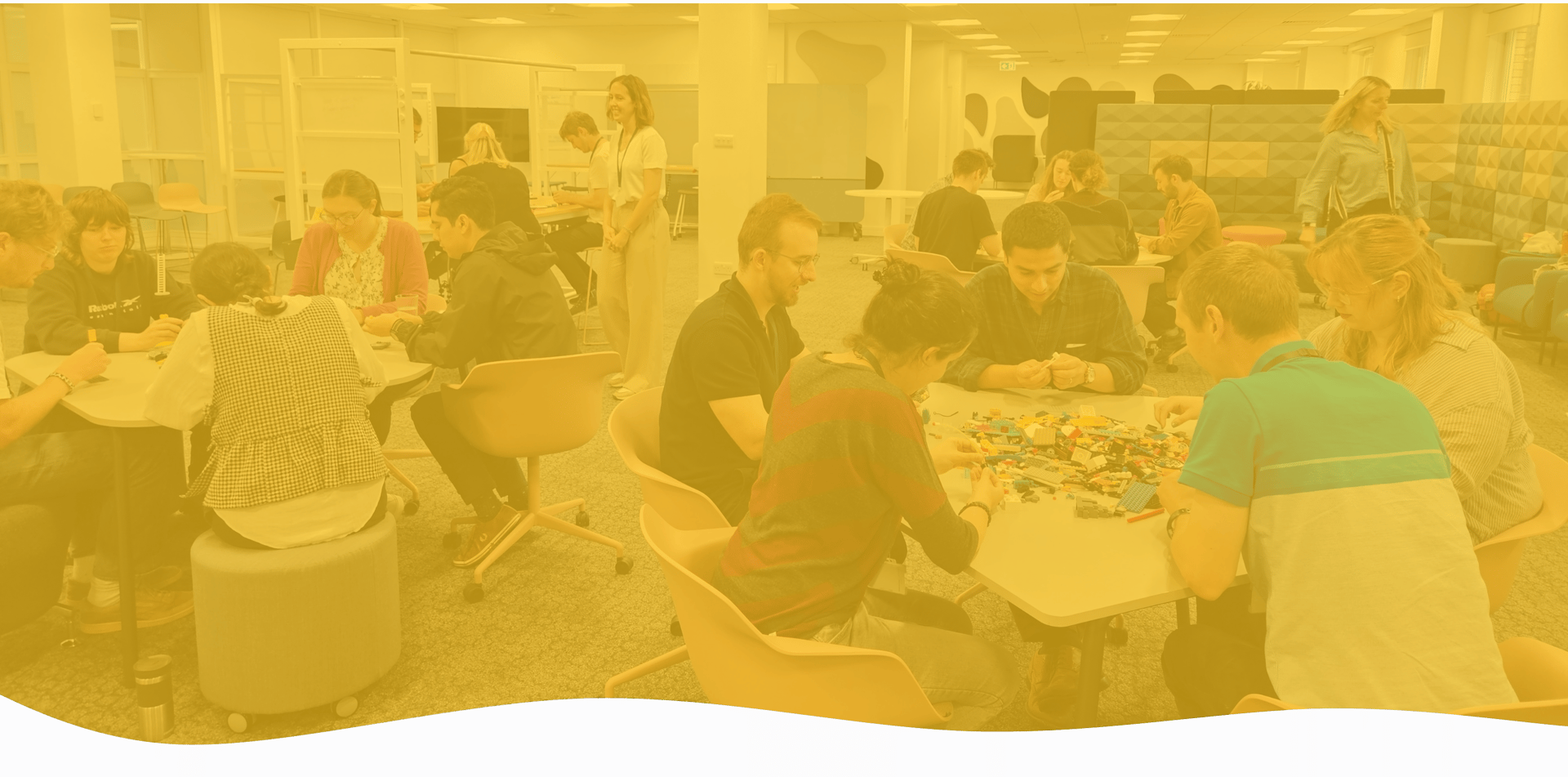 Workshop session with participants collaborating using Lego for team building activities