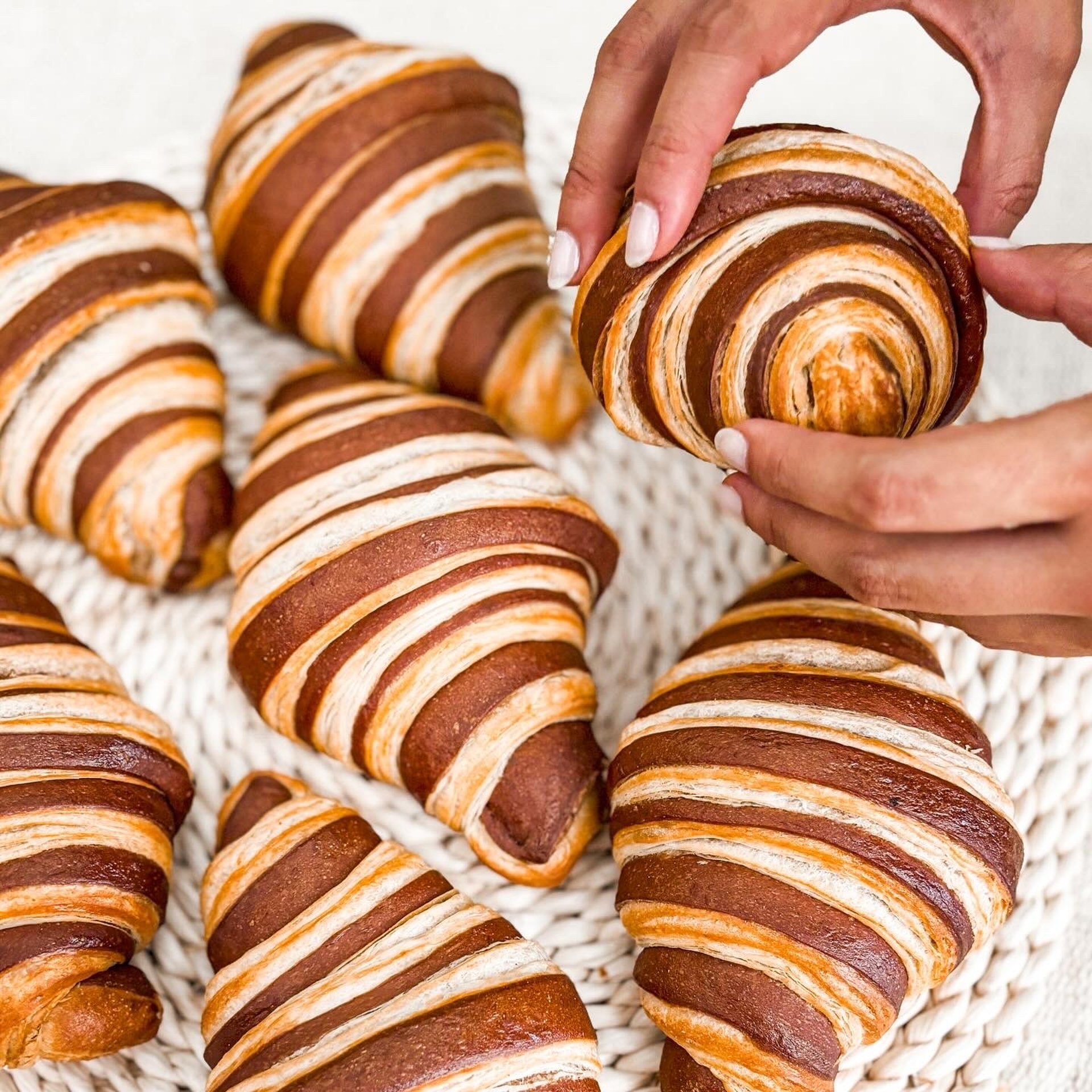 an abstract photo of a curved building with a blue sky in the background