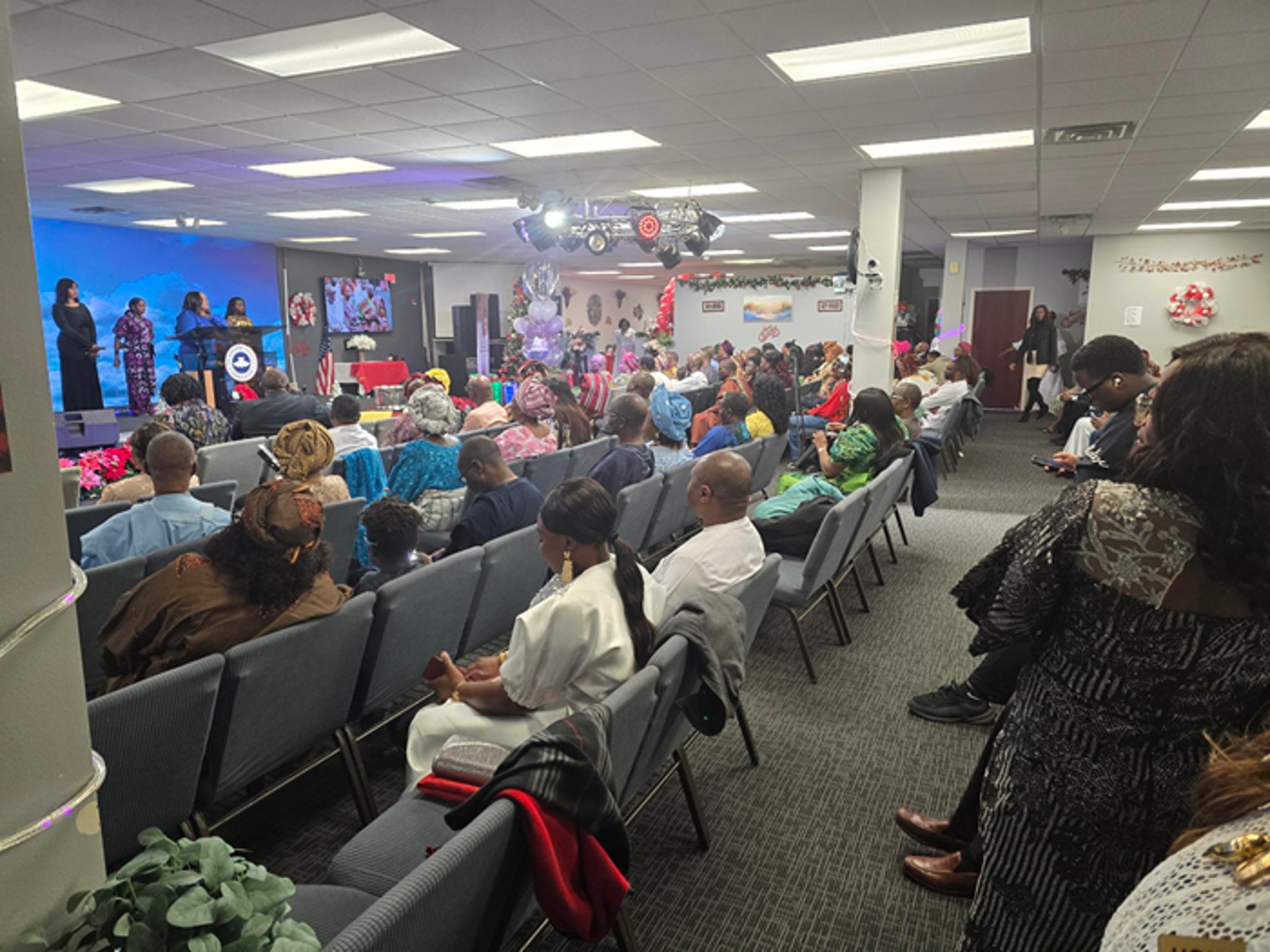person holding book on brown wooden table