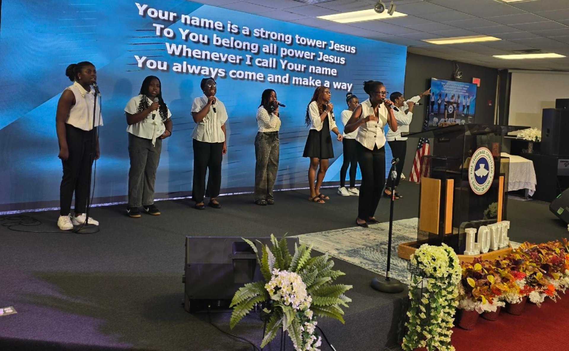 person holding book on brown wooden table