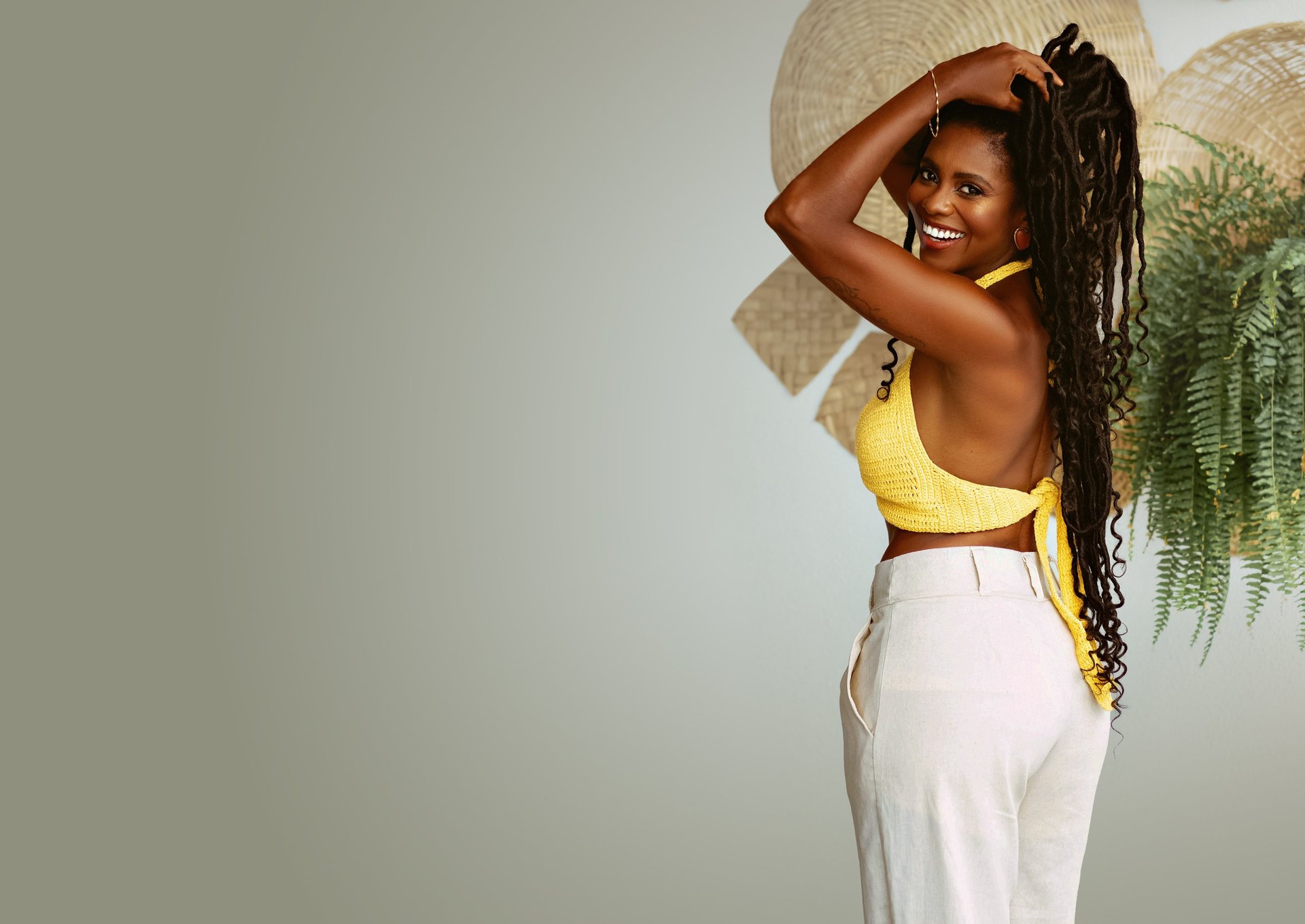 a woman with dreadlocks standing in a parking lot