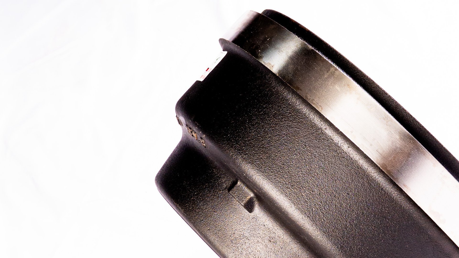 an abstract photo of a curved building with a blue sky in the background