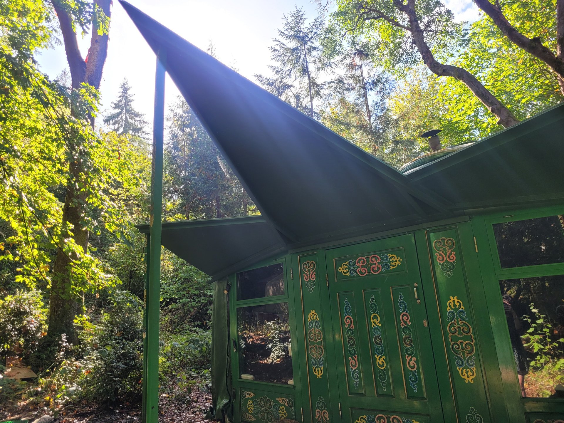 a yurt in the mountains with a yellow door