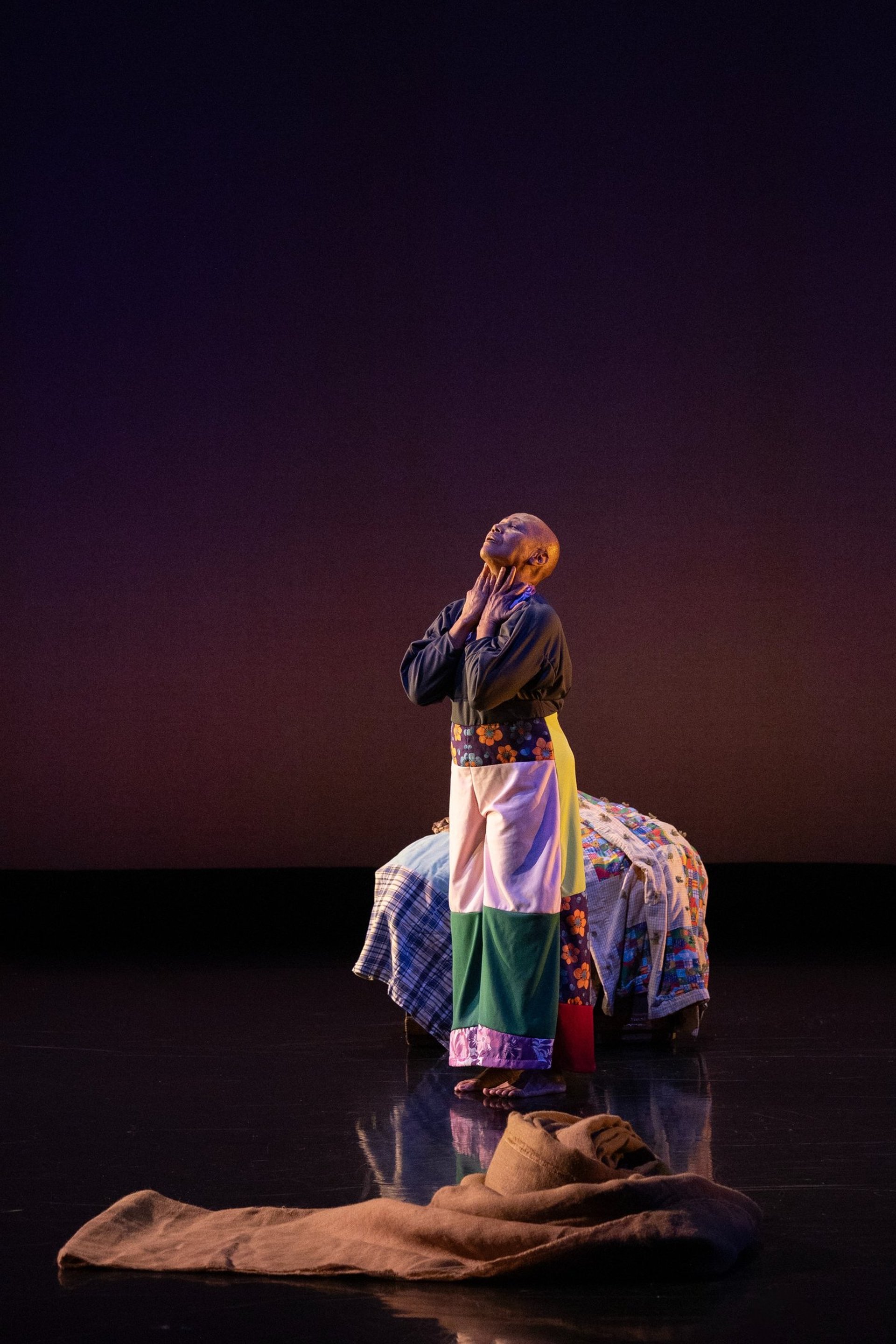 a close up of a colorful quilt on a bed