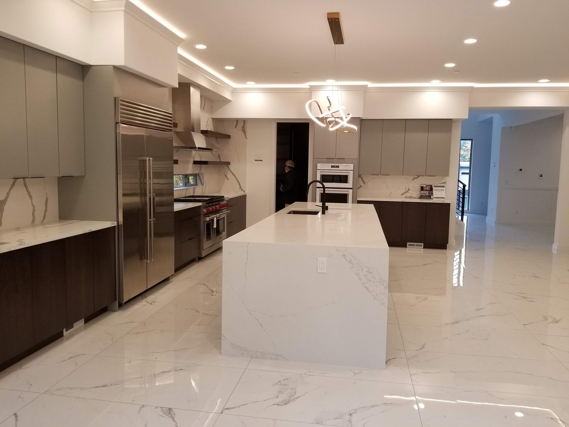 a large kitchen with a center island and bar stools