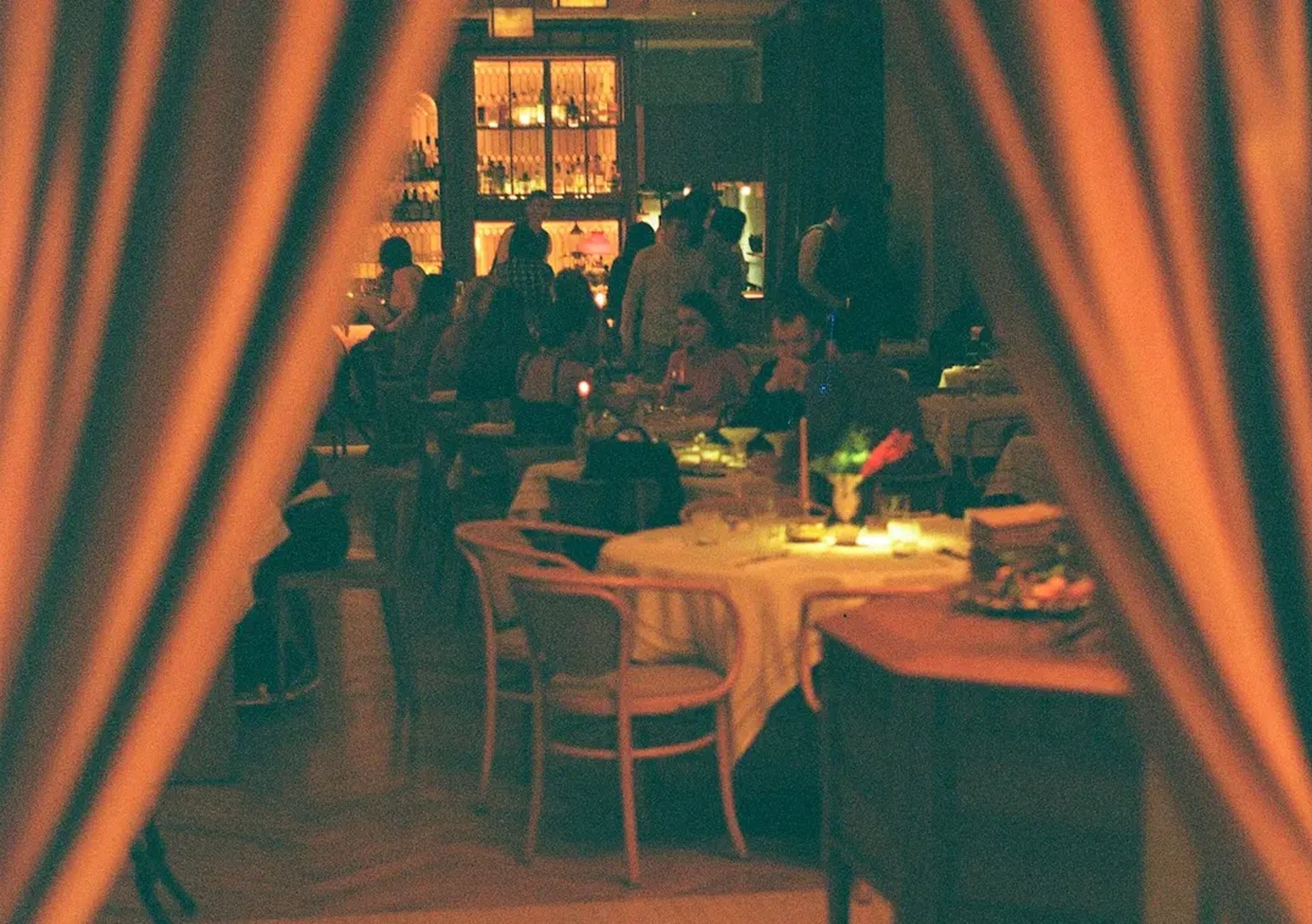 a group of people sitting at a table in a restaurant