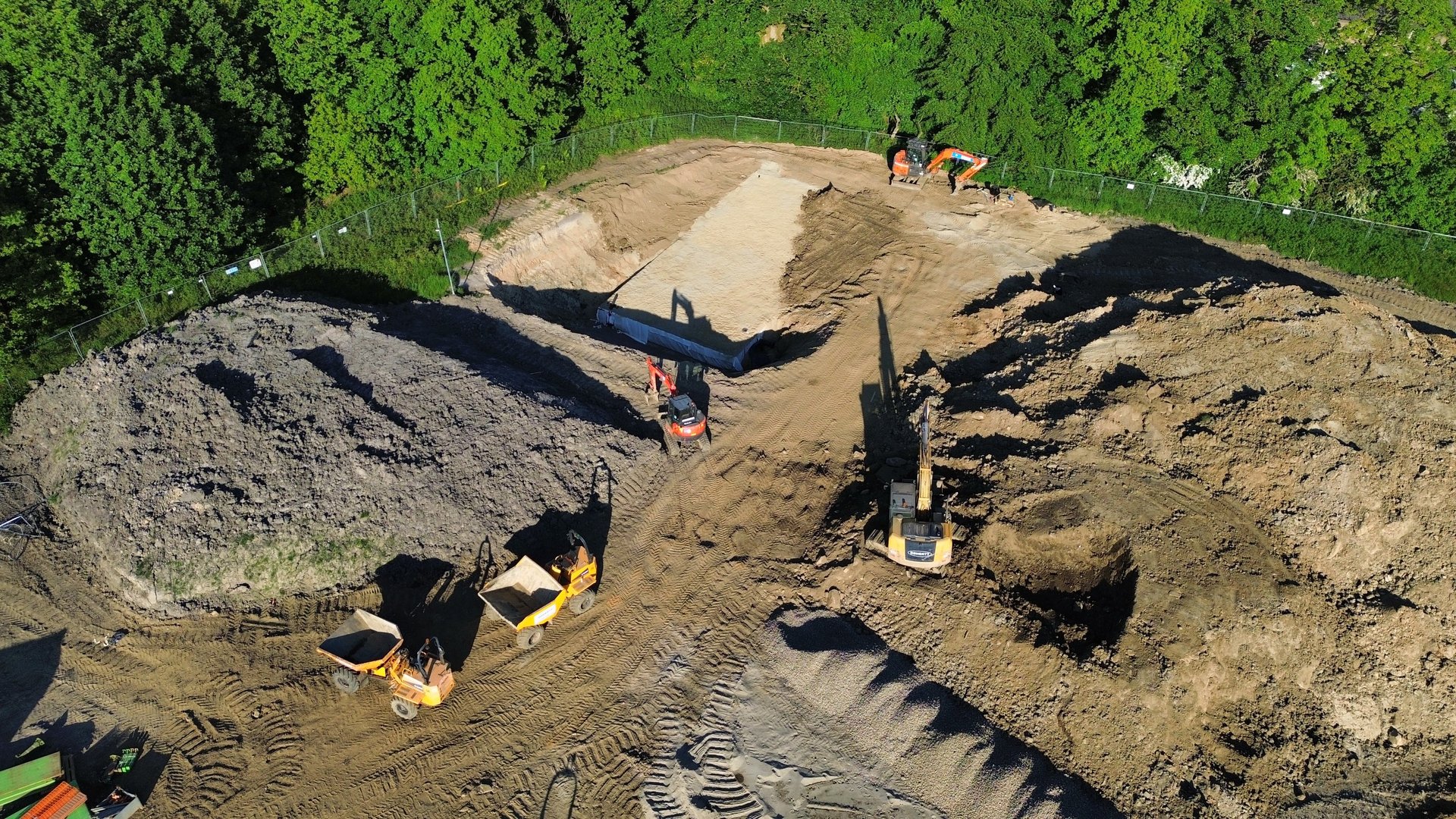 an abstract photo of a curved building with a blue sky in the background