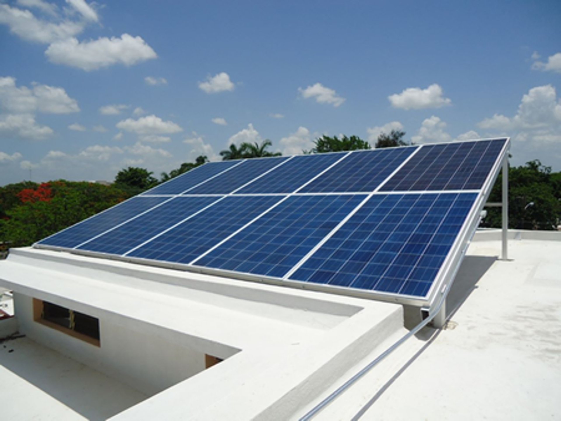 brown brick house with solar panels on roof