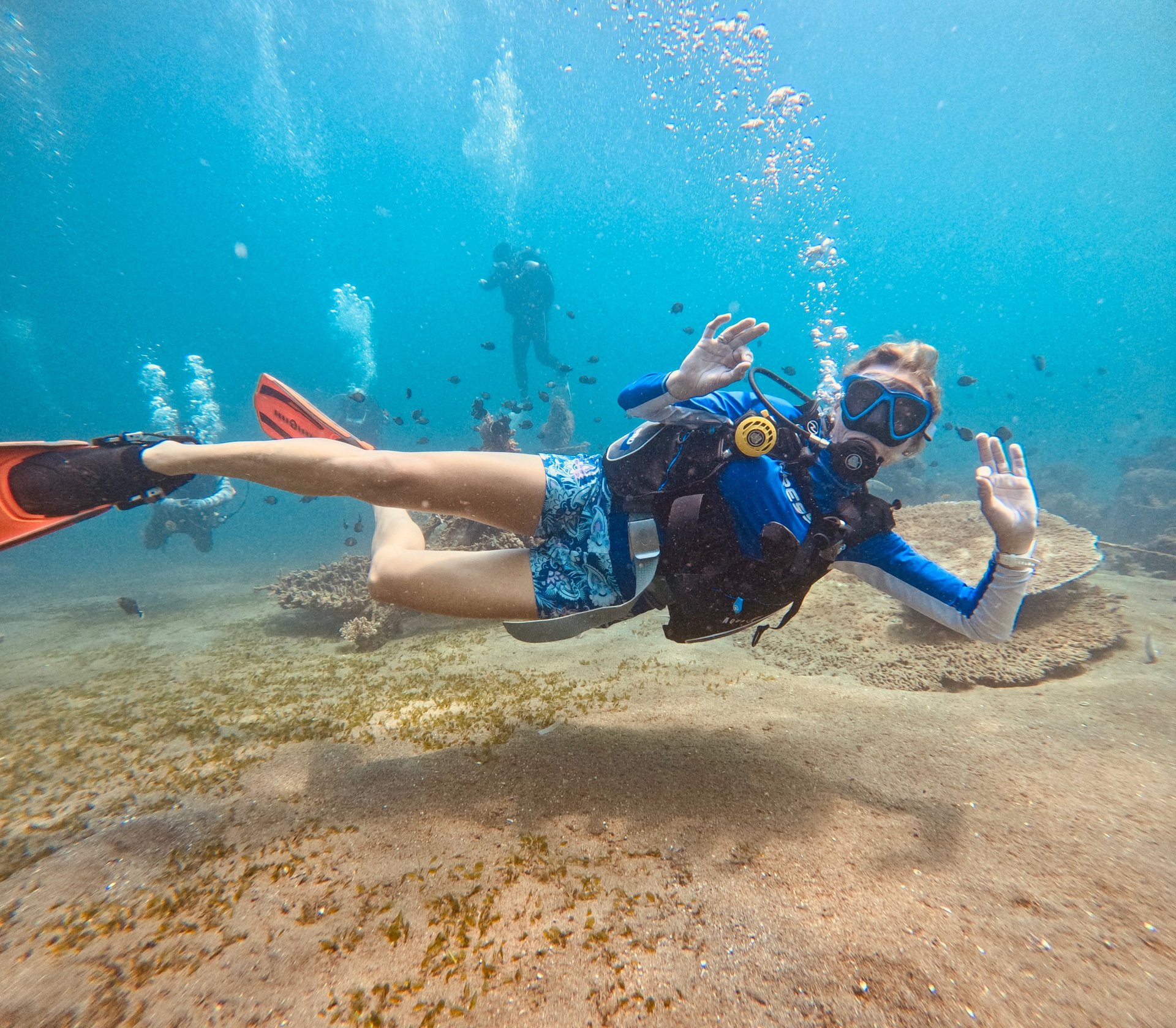 Female Scuba Diver in the water signaling ok, feeling happy and safe