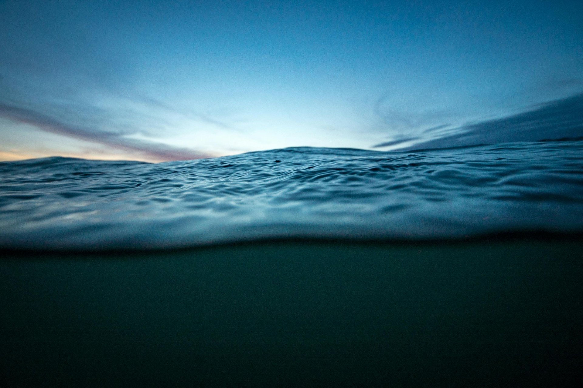 body of water between rock formation at daytime