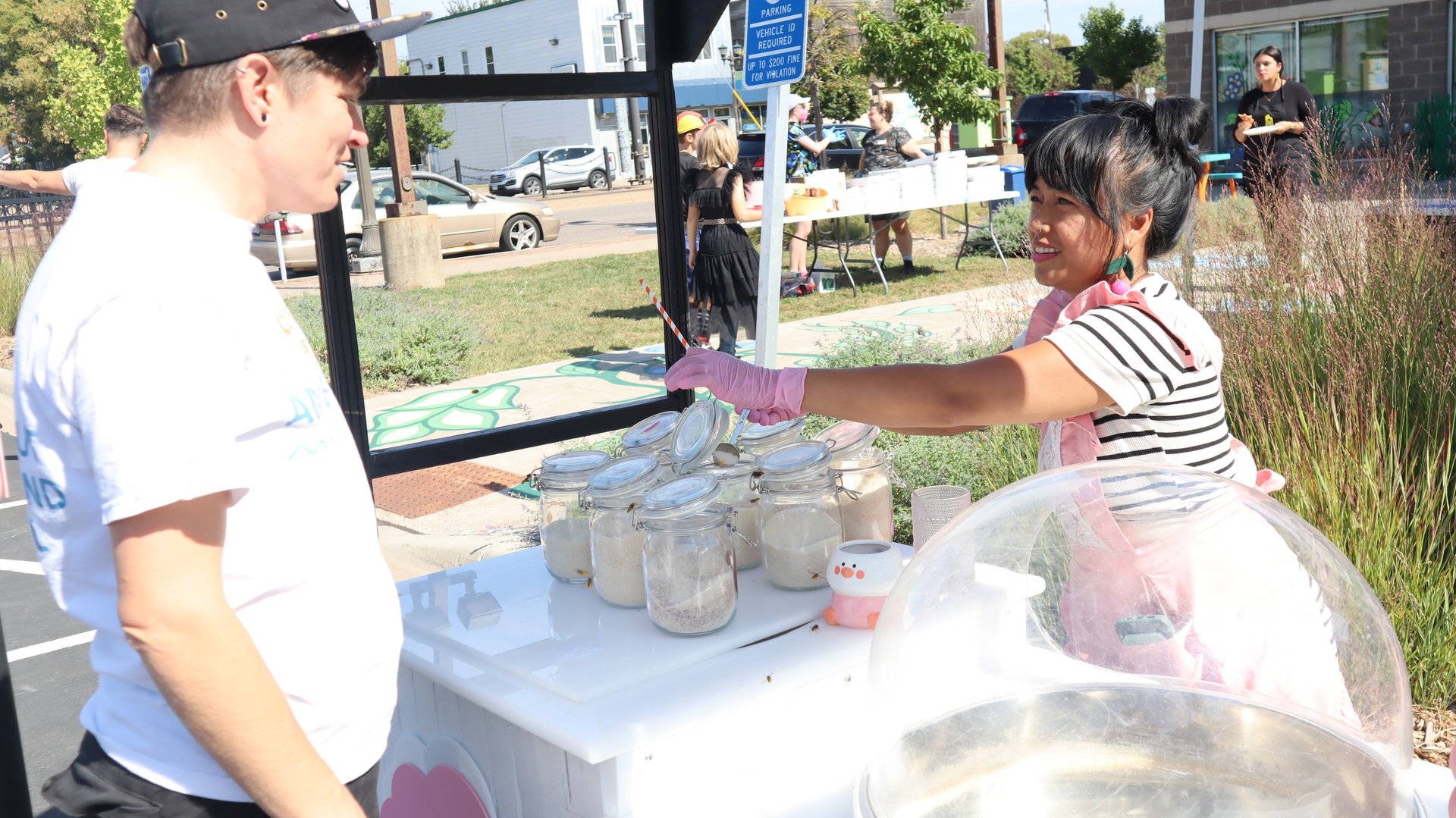 woman in white t-shirt standing beside woman in black and white stripe shirt
