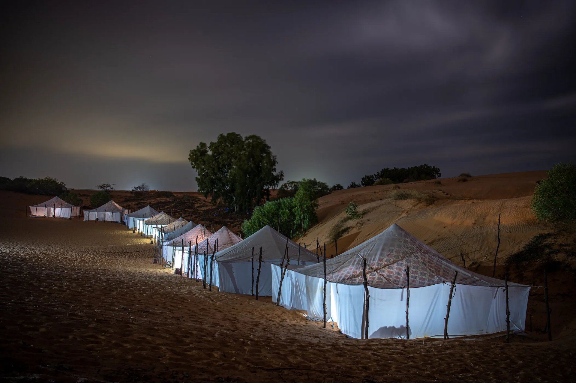 Narrow street lined with colorful buildings and flowers.