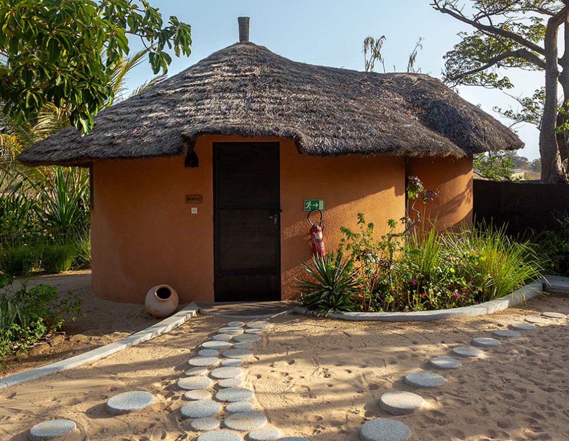 brown wooden shed surrounded body of water