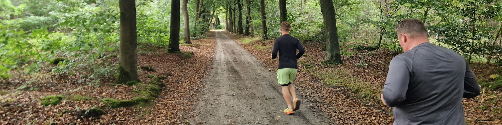 person cycling on road distance with mountain during daytime