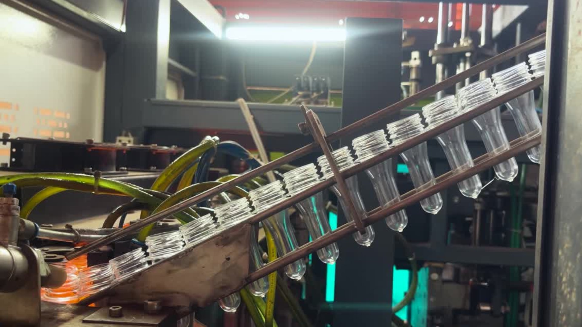 blue and black flashlight beside clear glass bottle