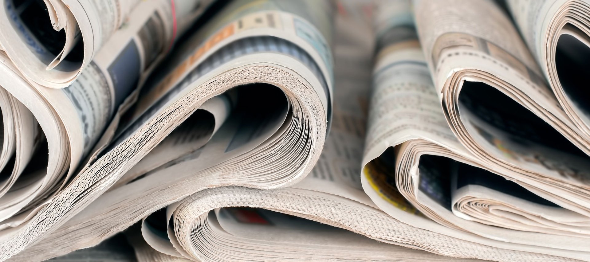 an abstract photo of a curved building with a blue sky in the background
