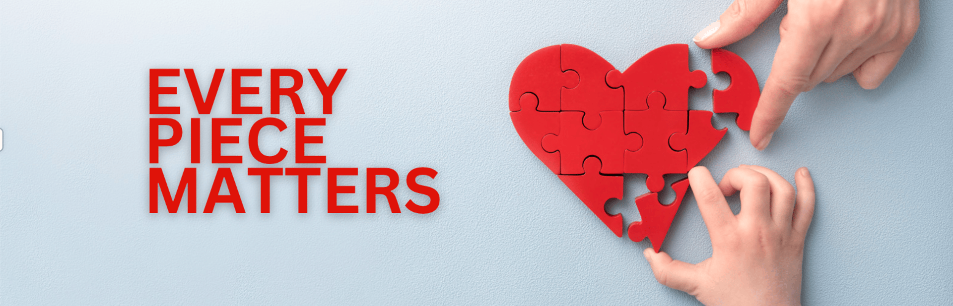 hands formed together with red heart paint