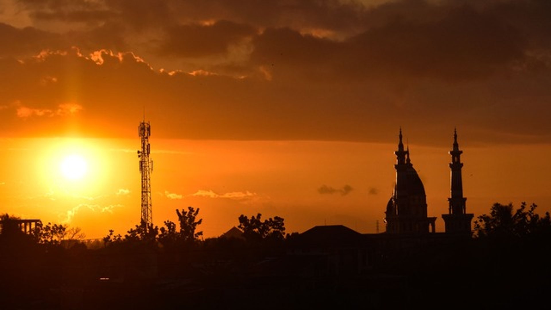 an abstract photo of a curved building with a blue sky in the background