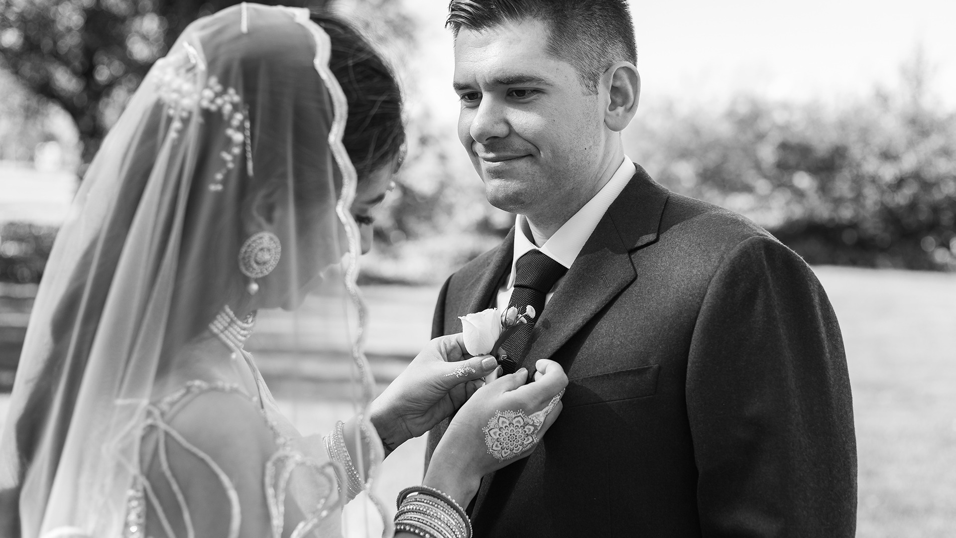Bride and groom under umbrellas, laughing during wedding photos in Canberra, wet weather wedding