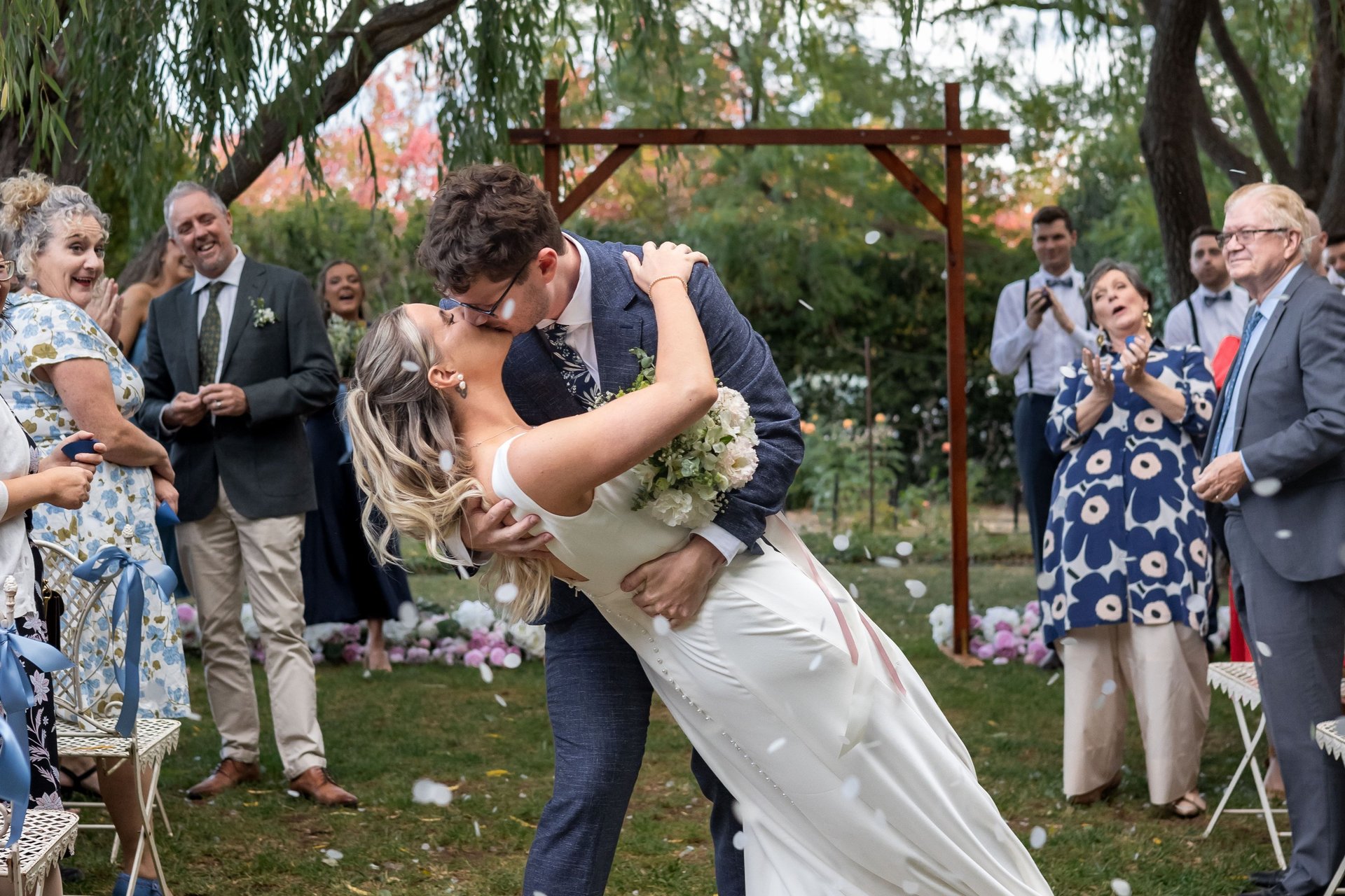 Bride and groom standing together smiling, black and white image with big tree in the background. Canberra wedding photograph