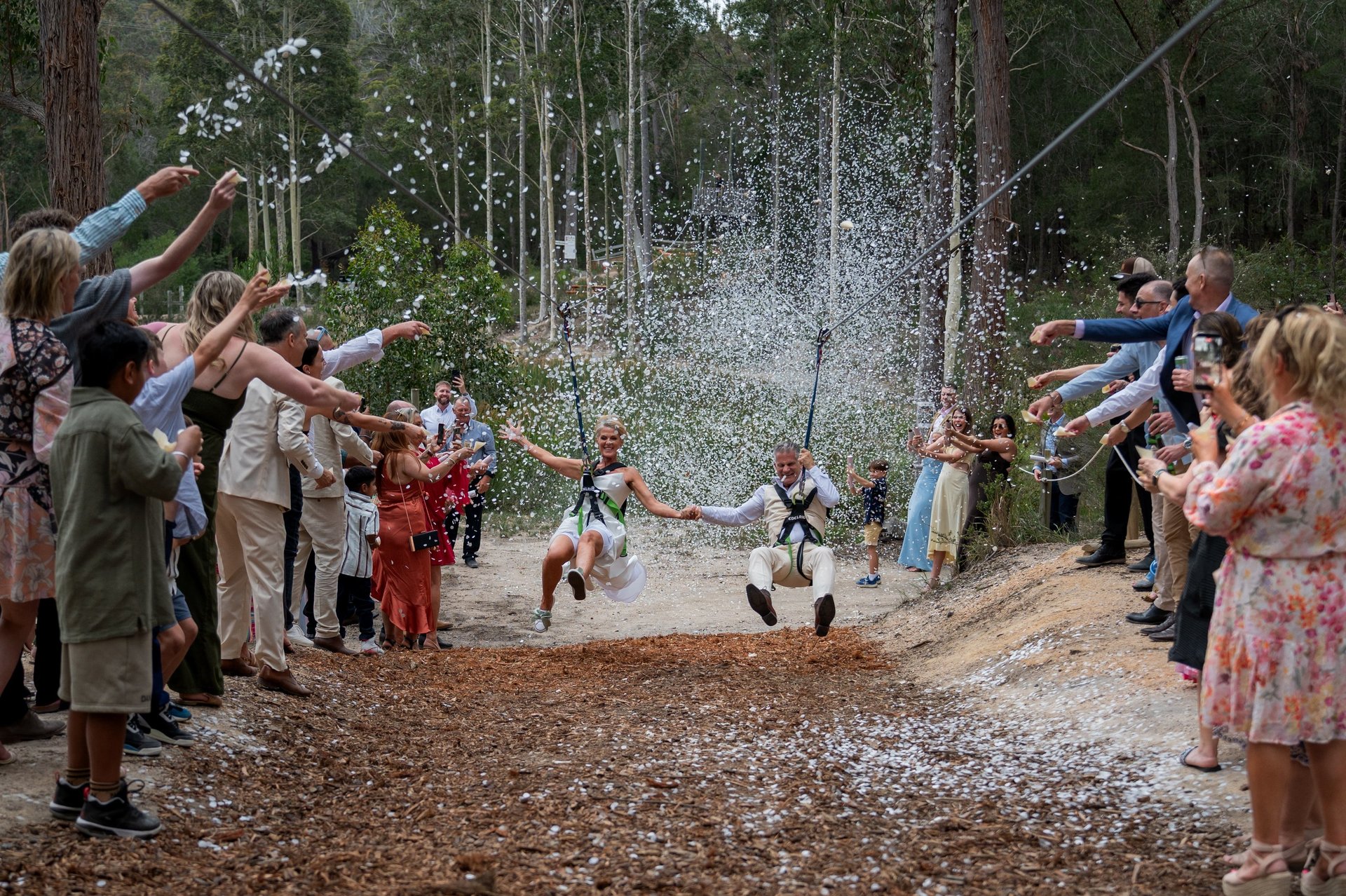 Bride and groom standing together smiling, black and white image with big tree in the background. Canberra wedding photograph