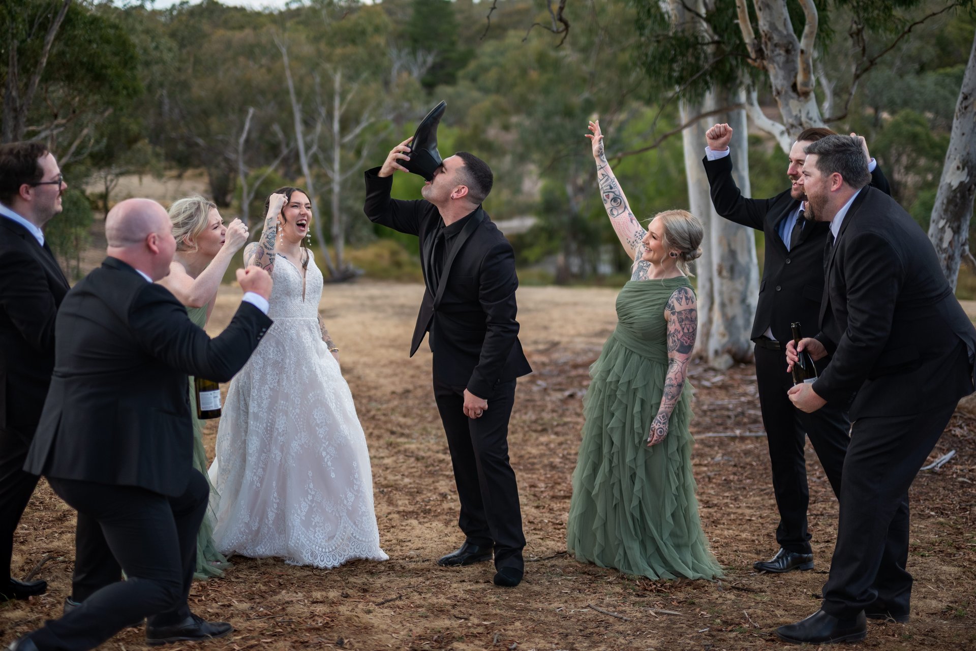 Bride and groom walking hand in hand through sparker exit, guests smiling, Canberra wedding photographer capturing moments