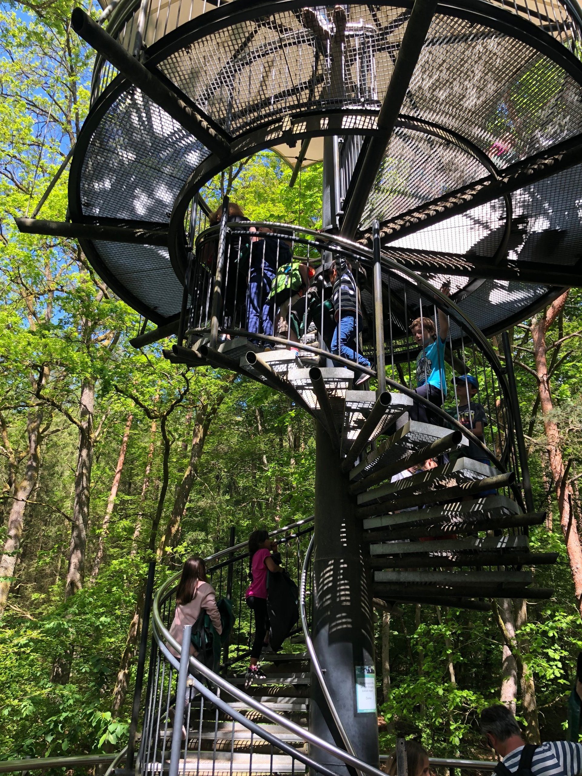 an abstract photo of a curved building with a blue sky in the background