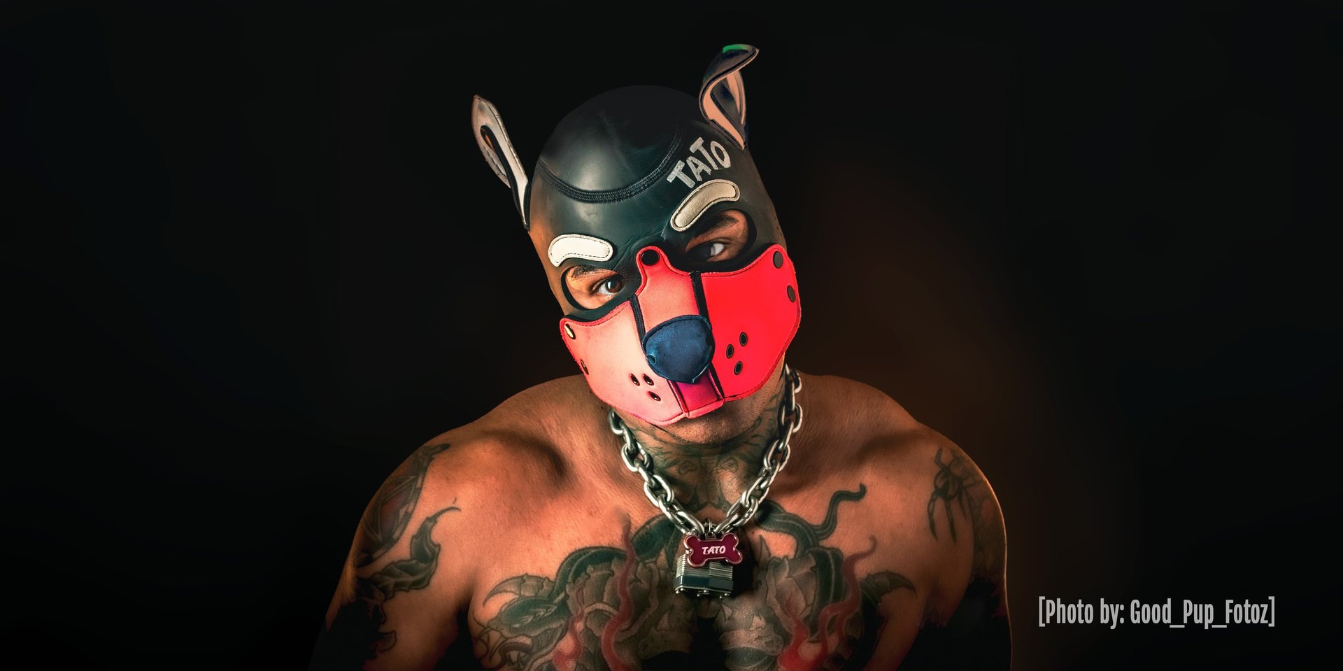 Man posing in pup mask. "TATO"