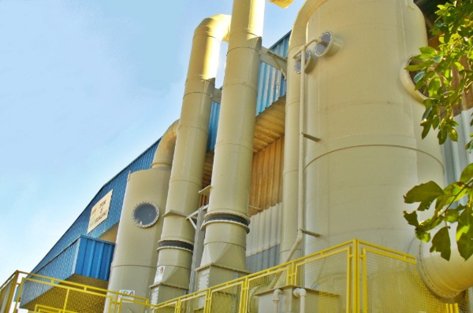 an abstract photo of a curved building with a blue sky in the background