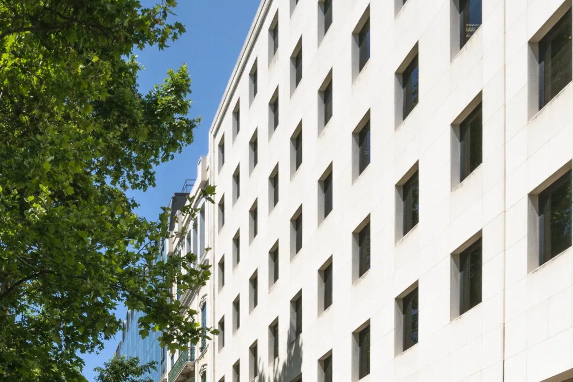 an abstract photo of a curved building with a blue sky in the background