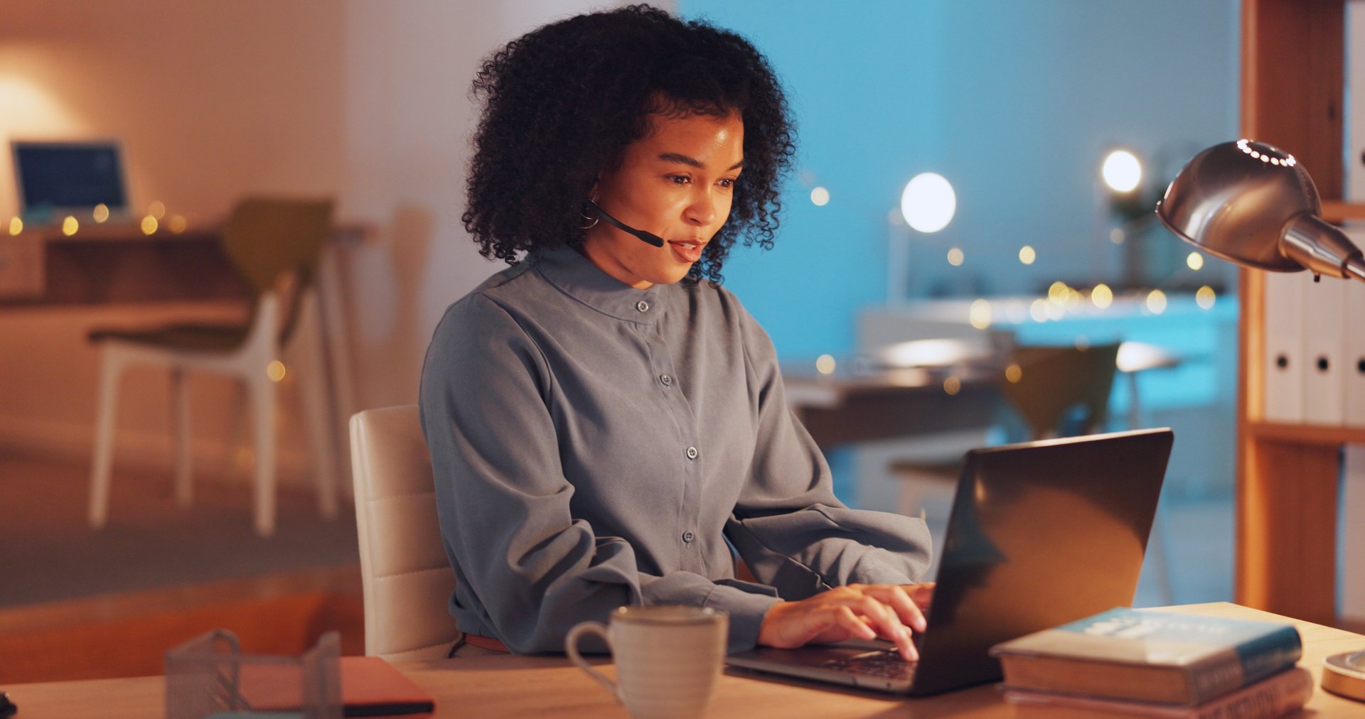 woman sitting on floor and leaning on couch using laptop