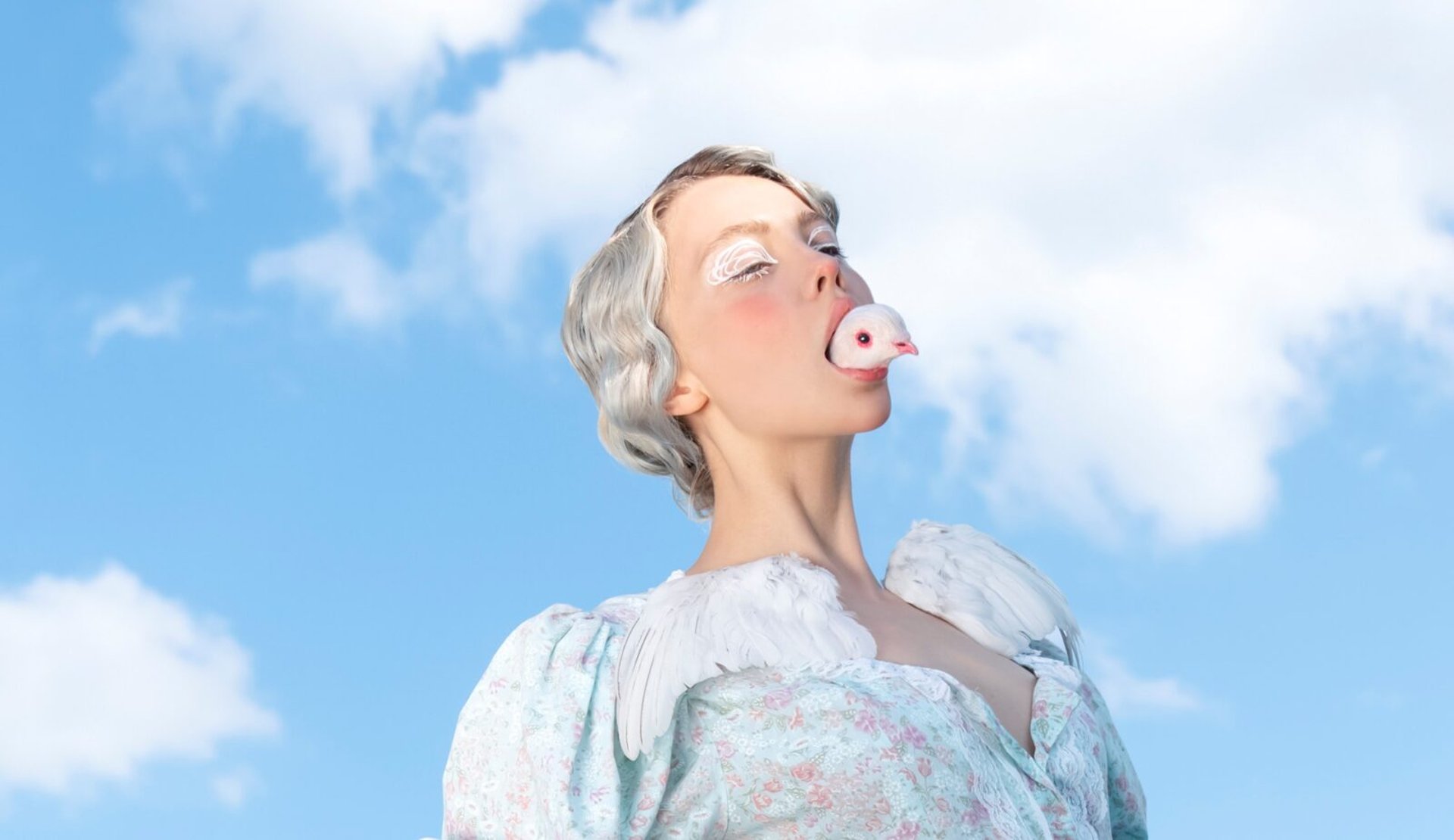 an abstract photo of a curved building with a blue sky in the background
