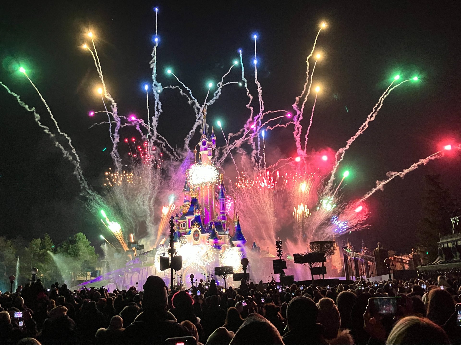 Fireworks going off behind Cinderella's castle in Disney for New Years Eve and New Years Day