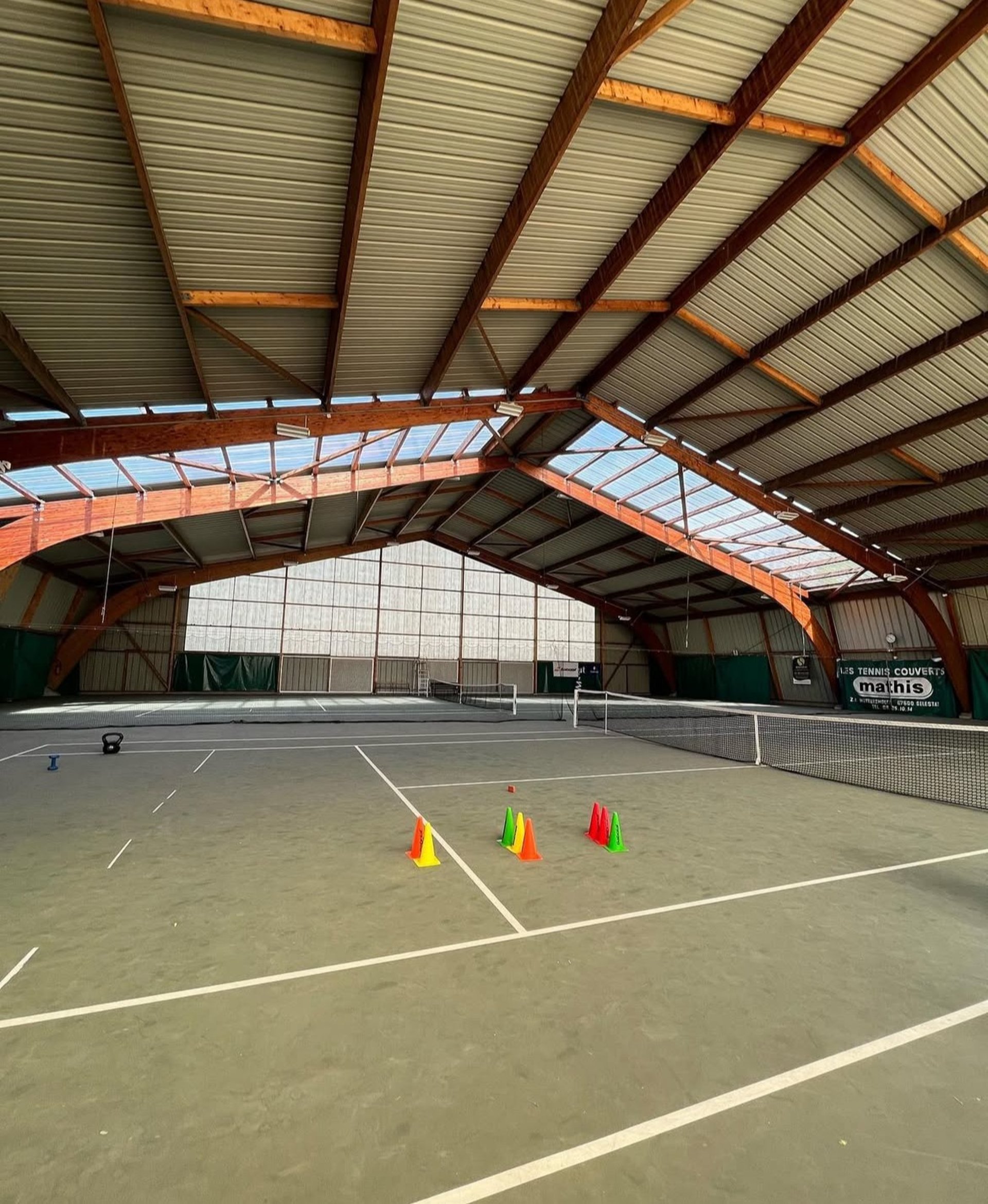a man standing on a tennis court holding a racquet