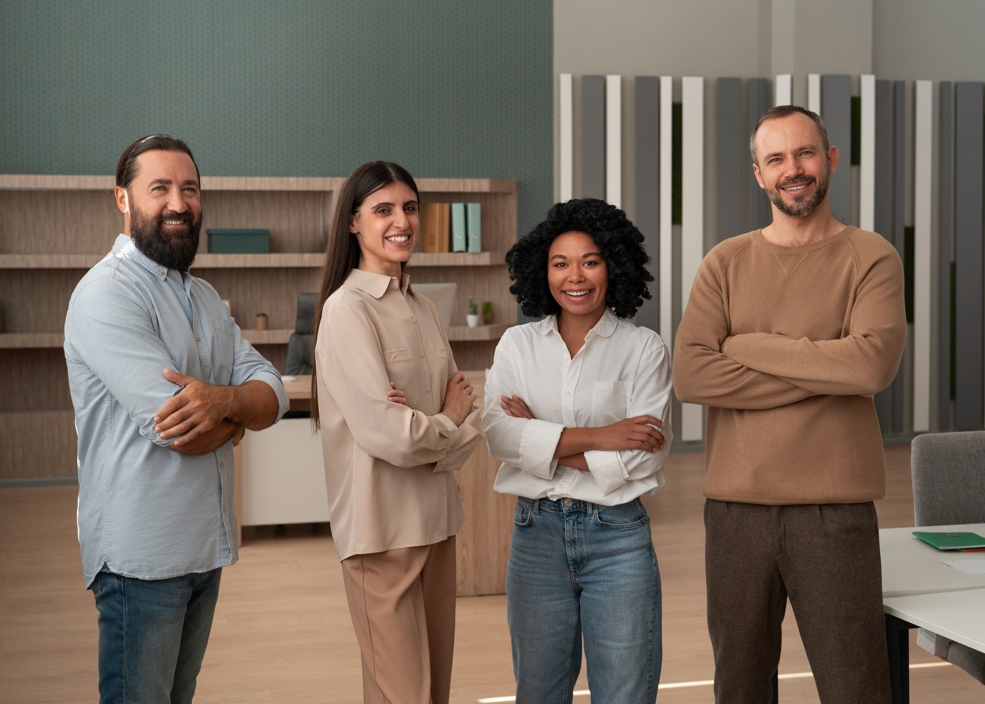 a group of people sitting at a table raising their hands