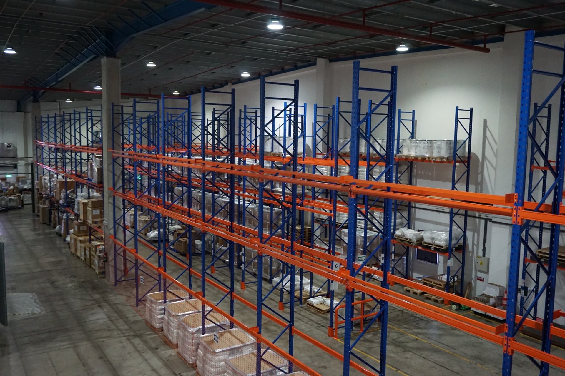 brown cardboard boxes on white metal rack