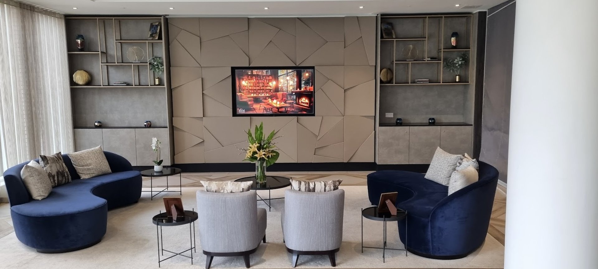 Custom built media wall with shelving and a TV featured in the center