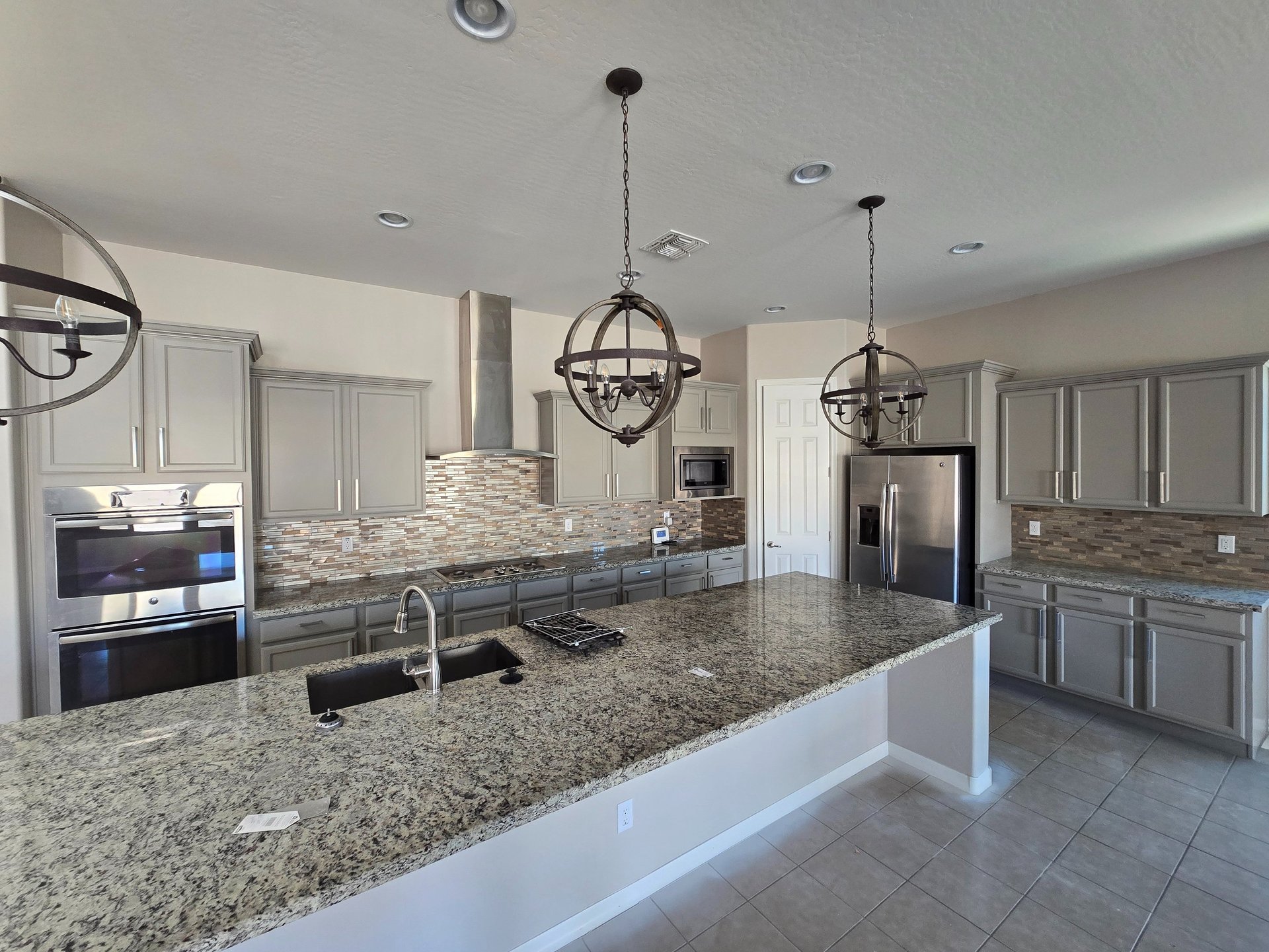 Updated kitchen with professionally refinished gray cabinets in Phoenix, enhancing the space with a modern and stylish finish