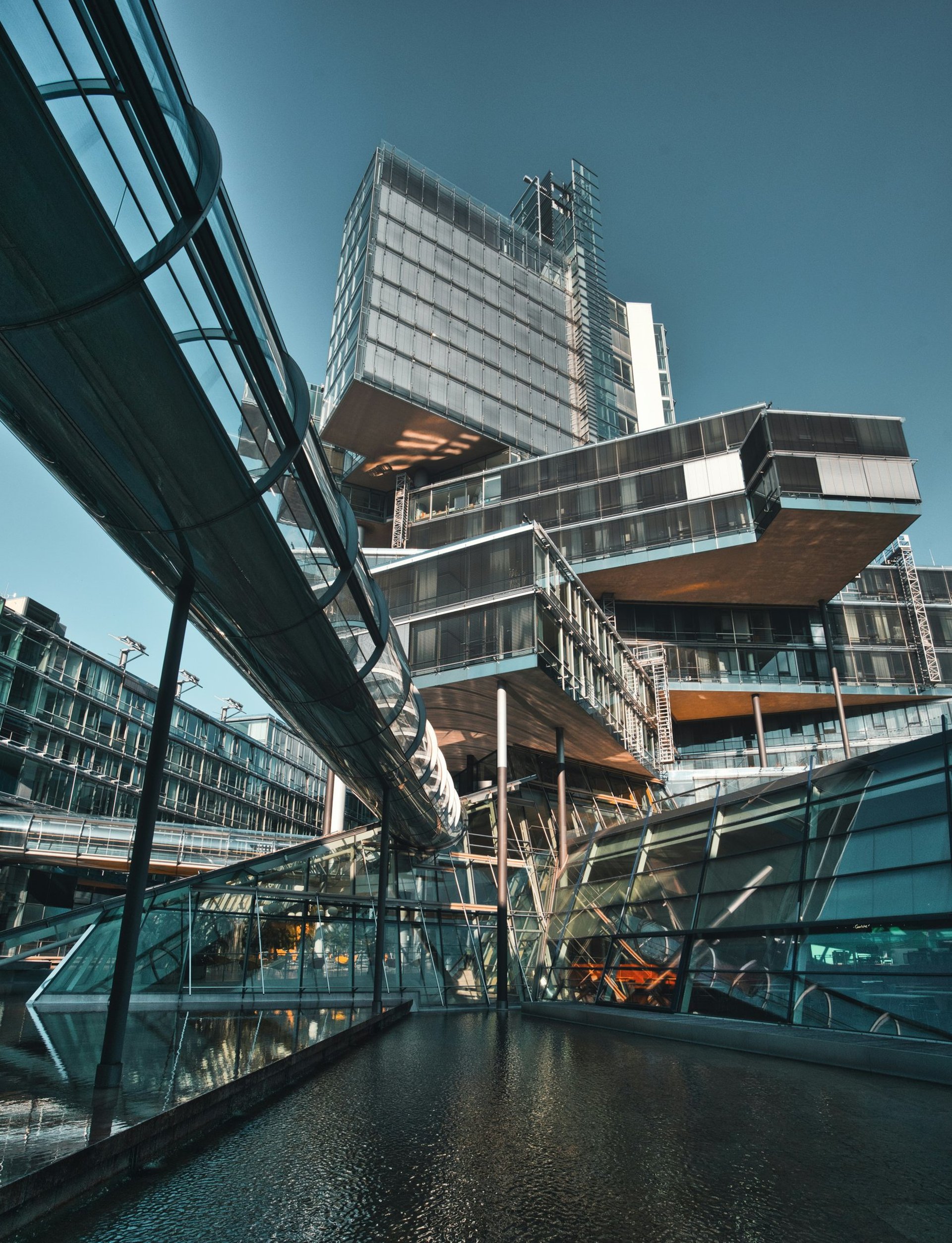 an abstract photo of a curved building with a blue sky in the background