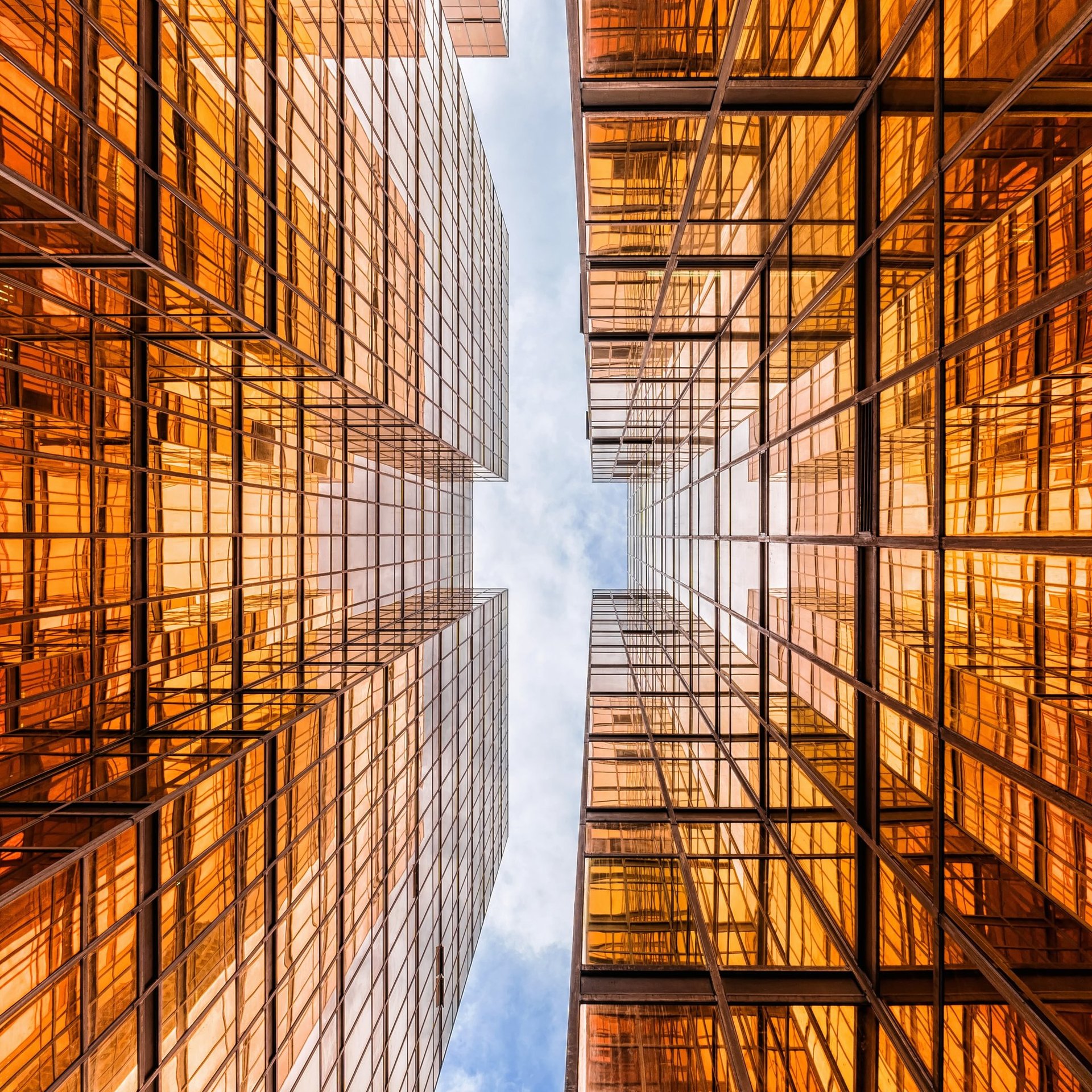 an abstract photo of a curved building with a blue sky in the background