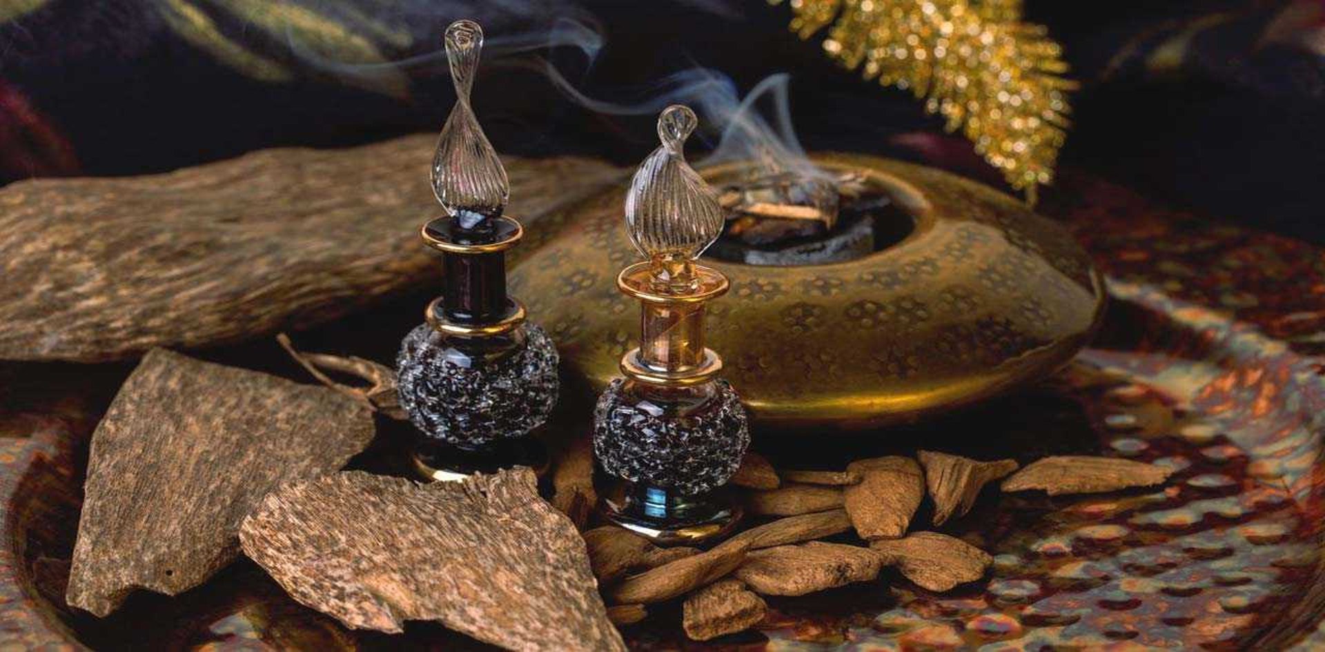 selective focus photography of clear glass perfume bottle