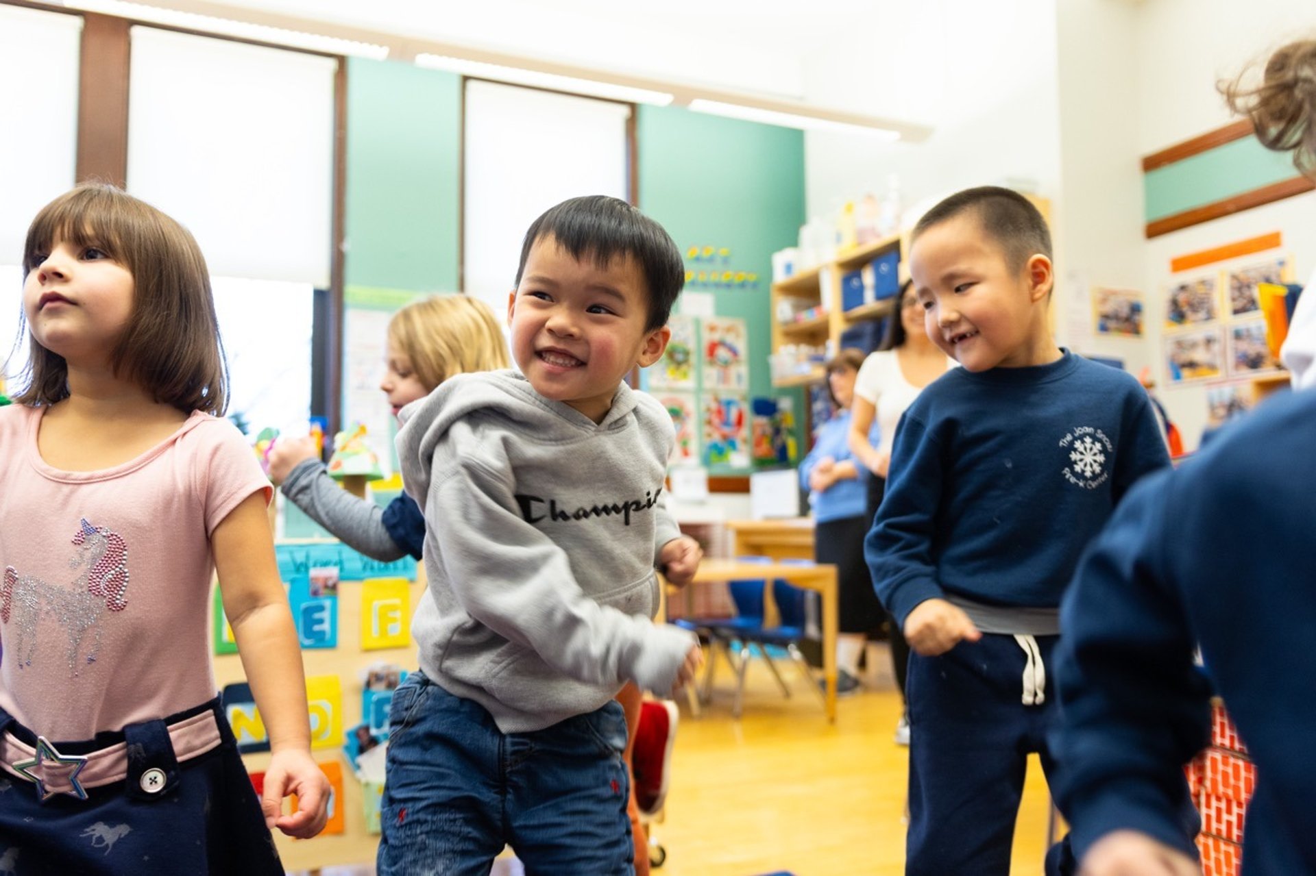 PreK students moving their bodies during a lesson.