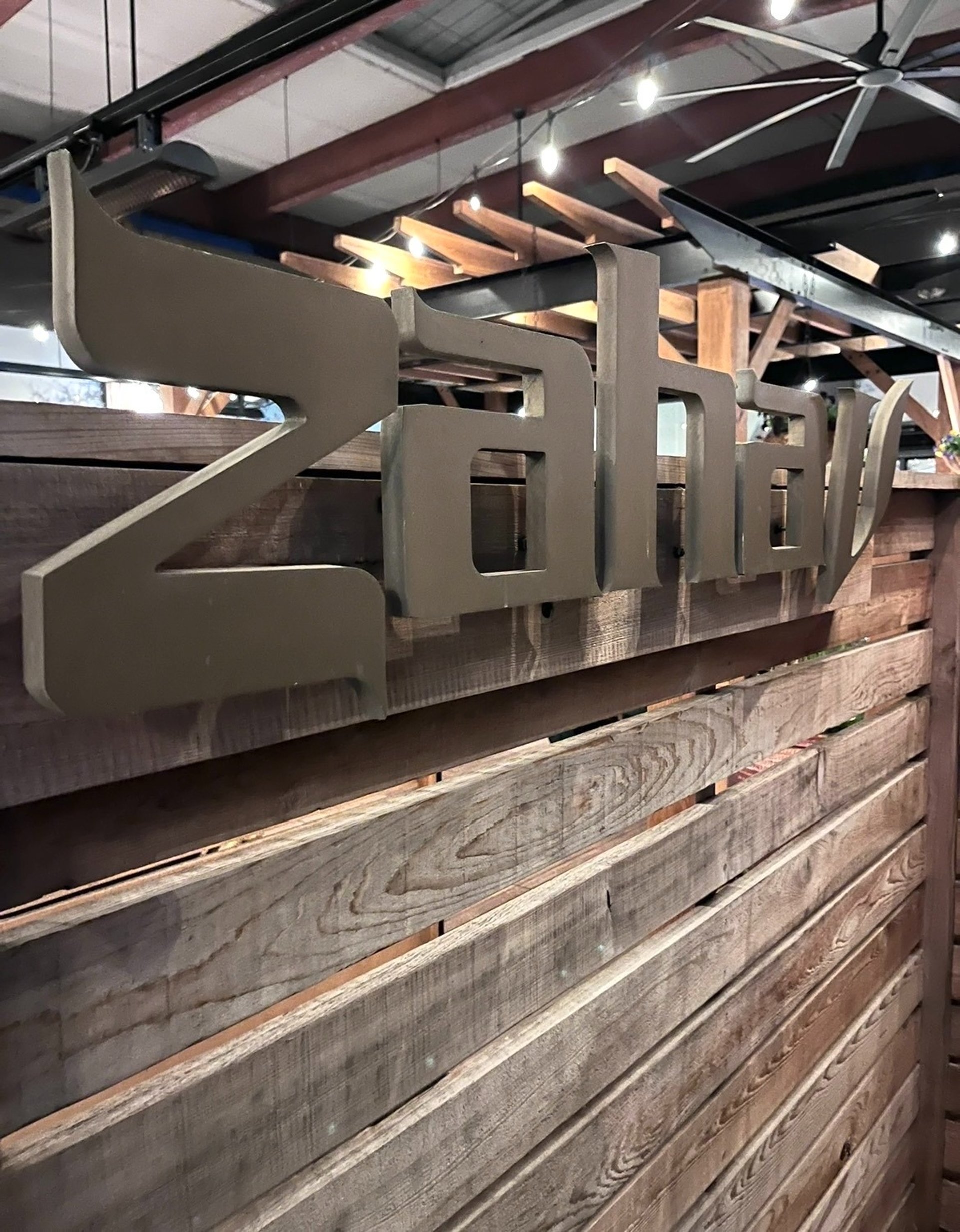 an abstract photo of a curved building with a blue sky in the background