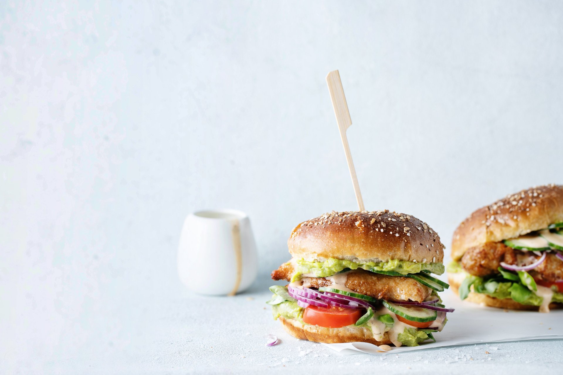 shallow focus photo of person holding hamburger