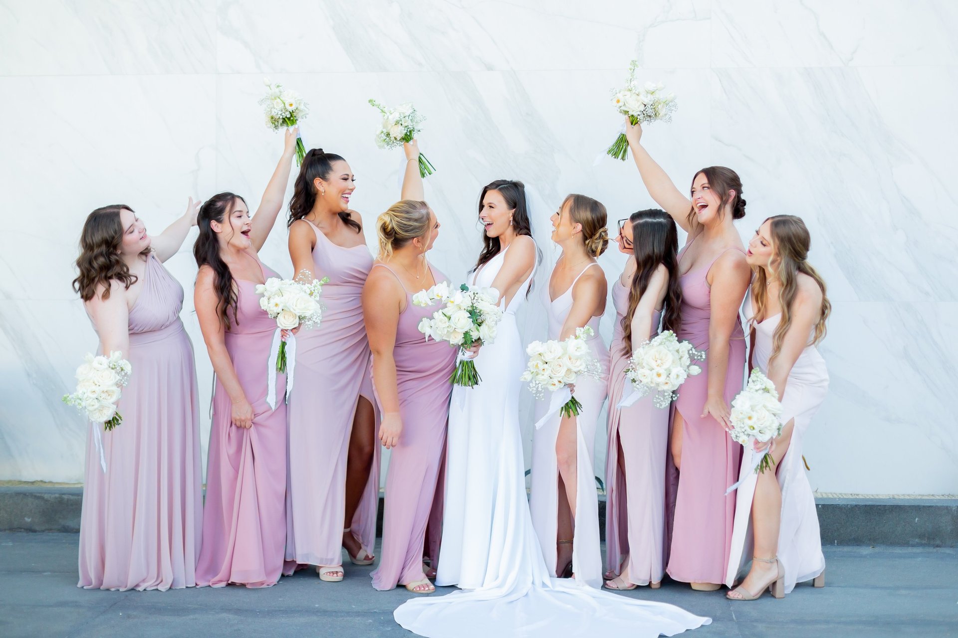 A moment captured by Los Cabos Wedding Films at the Garza Blanca Hotel in San José del Cabo: Bridesmaids raising their floral