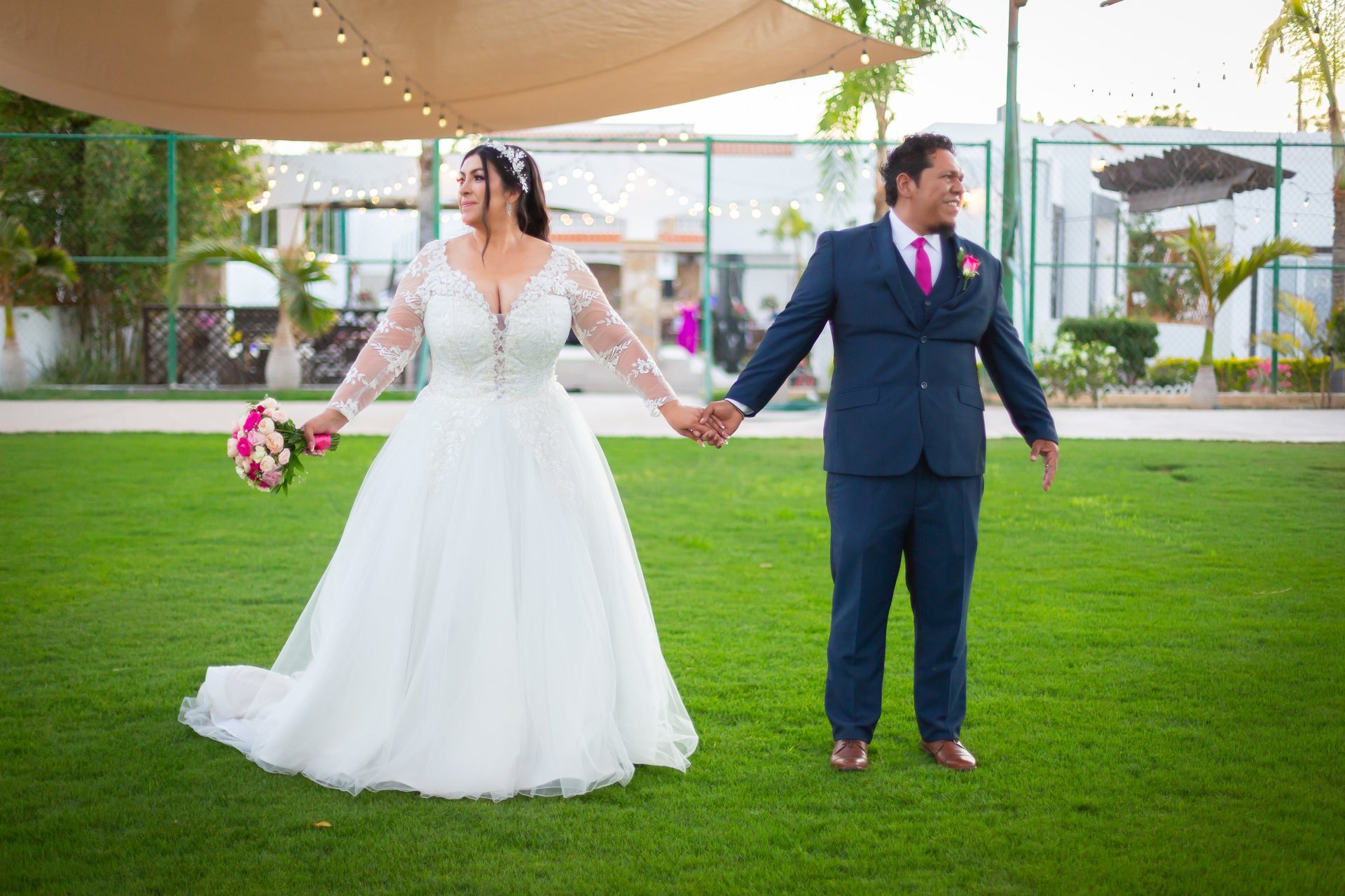 A moment captured by Los Cabos Wedding Films at the Garza Blanca Hotel in San José del Cabo: Bridesmaids raising their floral