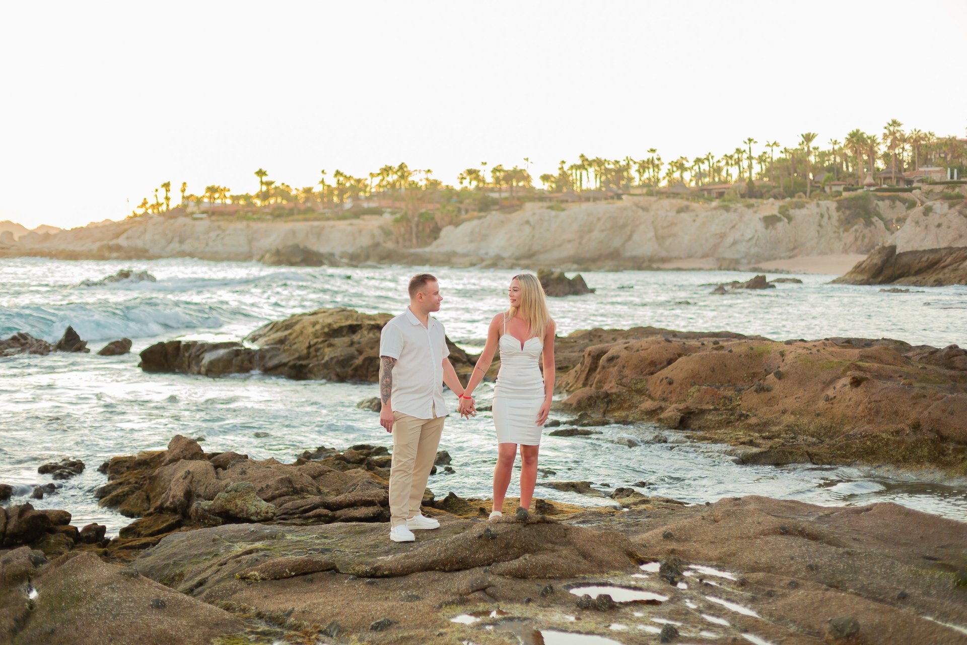A moment captured by Los Cabos Wedding Films at the Garza Blanca Hotel in San José del Cabo: Bridesmaids raising their floral